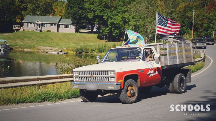 White/red flatbed with flags